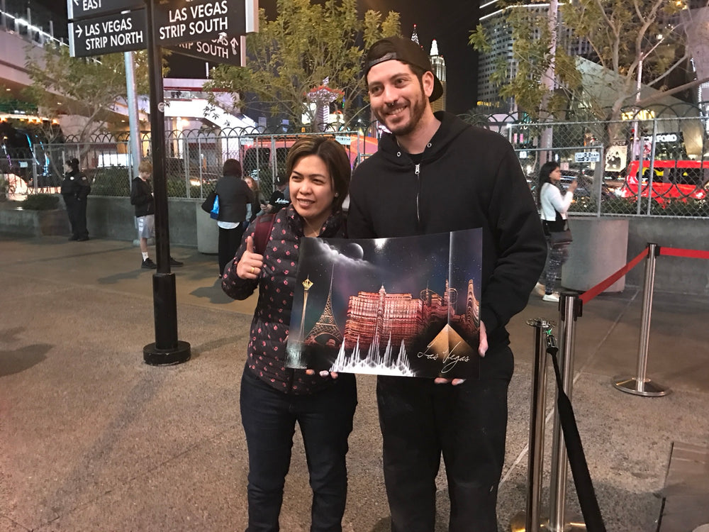 Happy VegasSprays collectors holding a Las Vegas painting