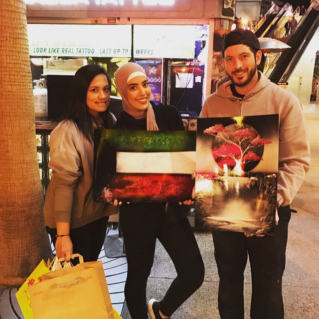 Happy VegasSprays collectors holding original paintings