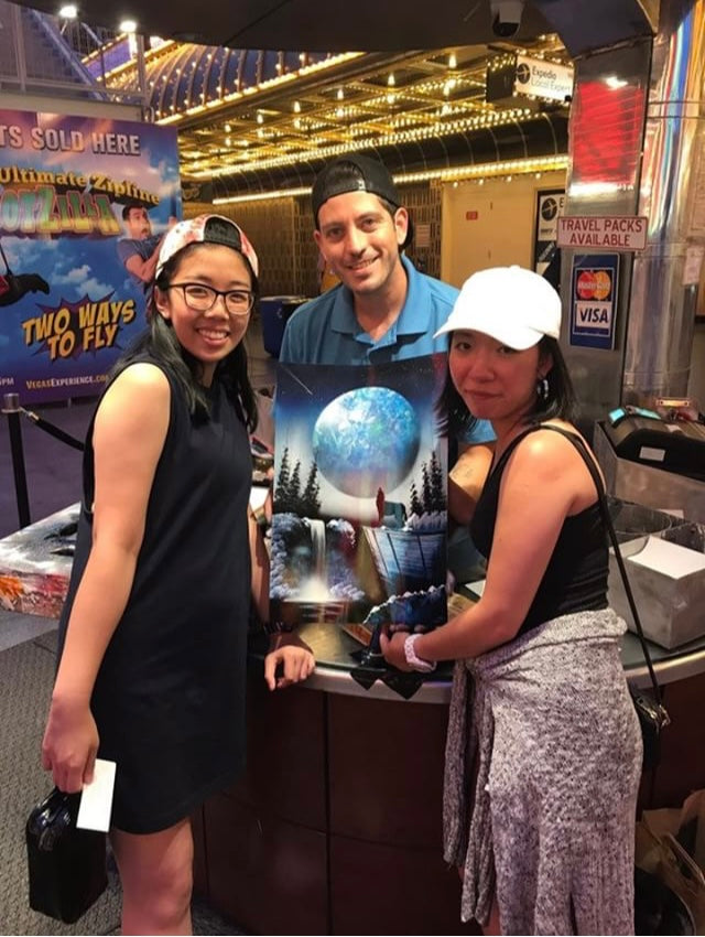 Collectors with an original moon landscape painting