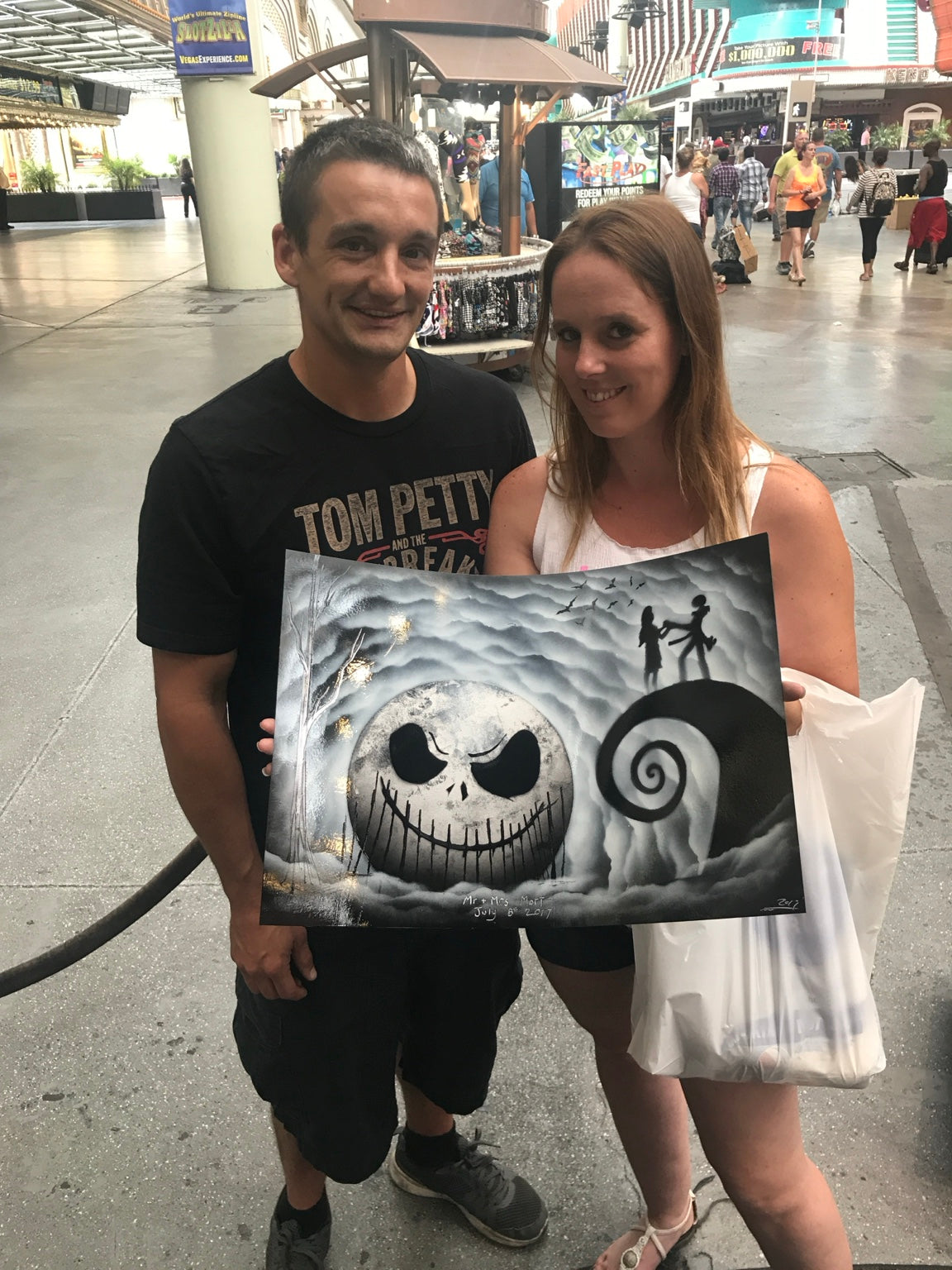 Happy couple holding their custom spray painting