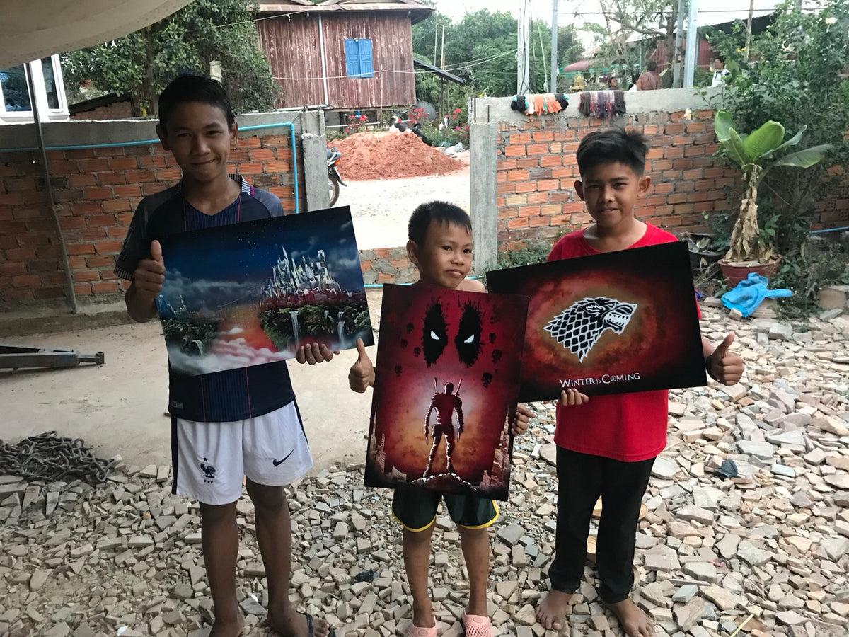 Young collectors holding their VegasSprays paintings