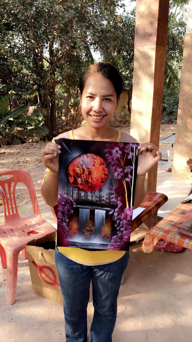 Collector holding a colorful waterfall spray painting