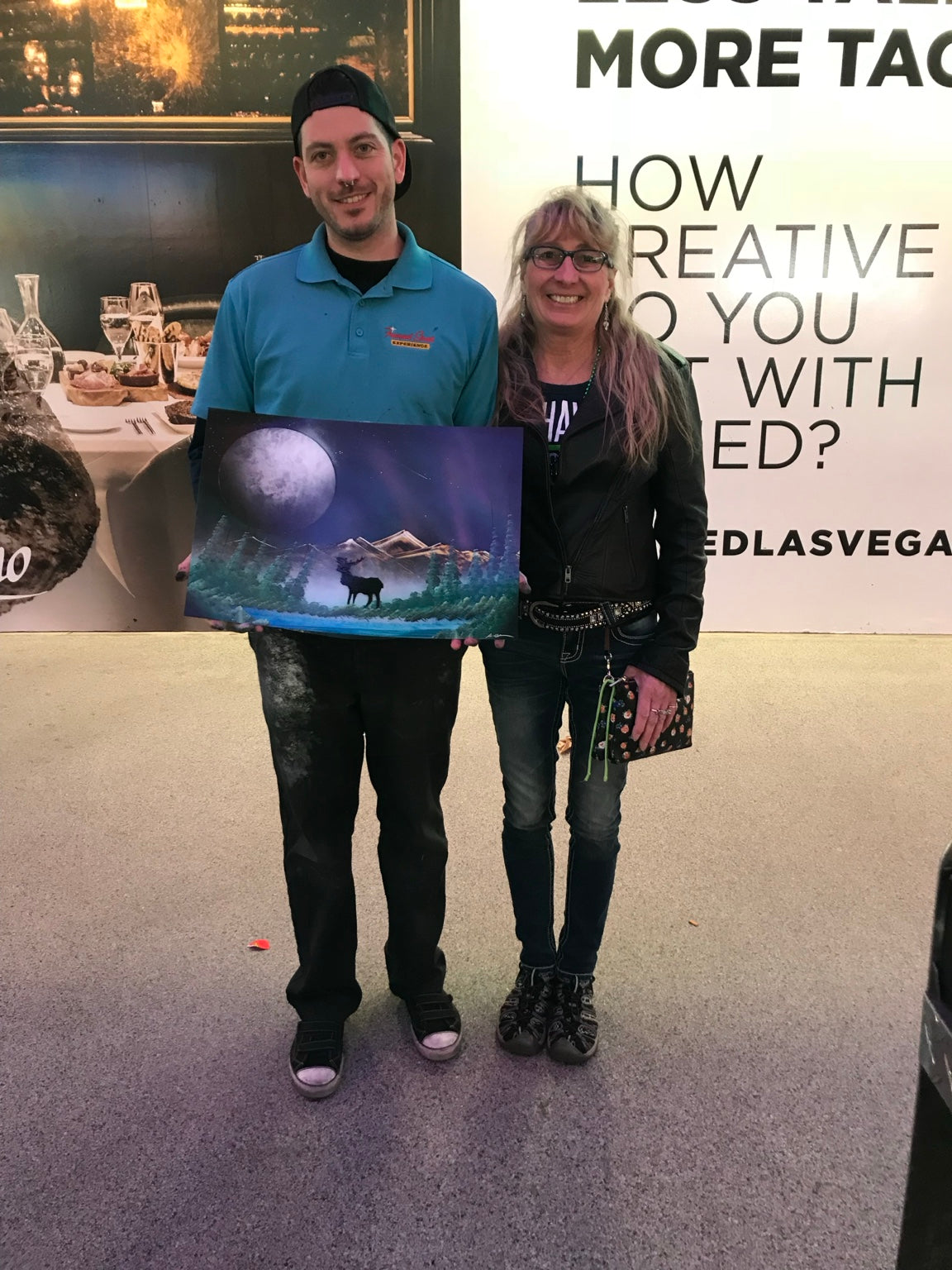 Happy VegasSprays collector holding an original moon painting